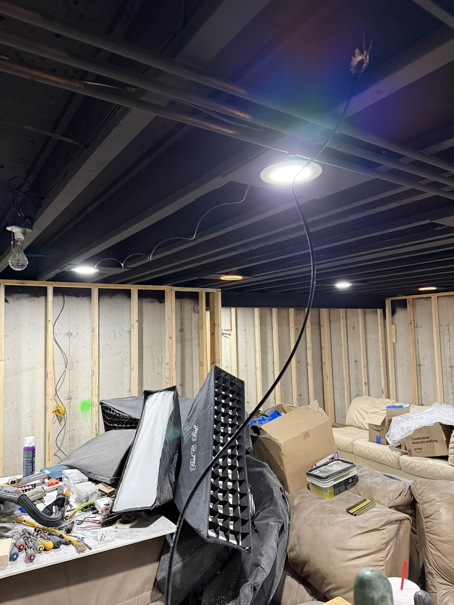 New network cable being pulled through an open basement ceiling