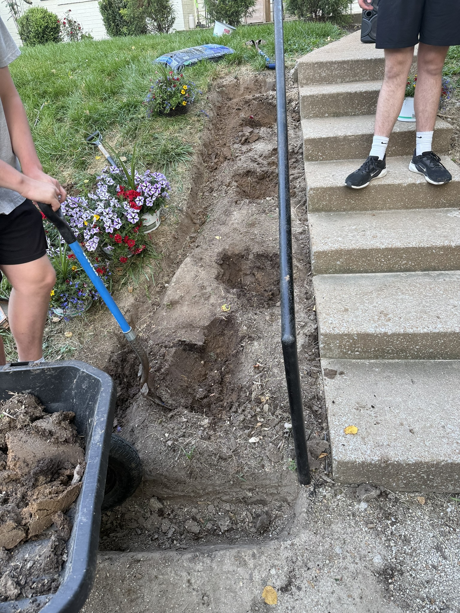 Soil preparation beside the front steps before the finished planting and lighting