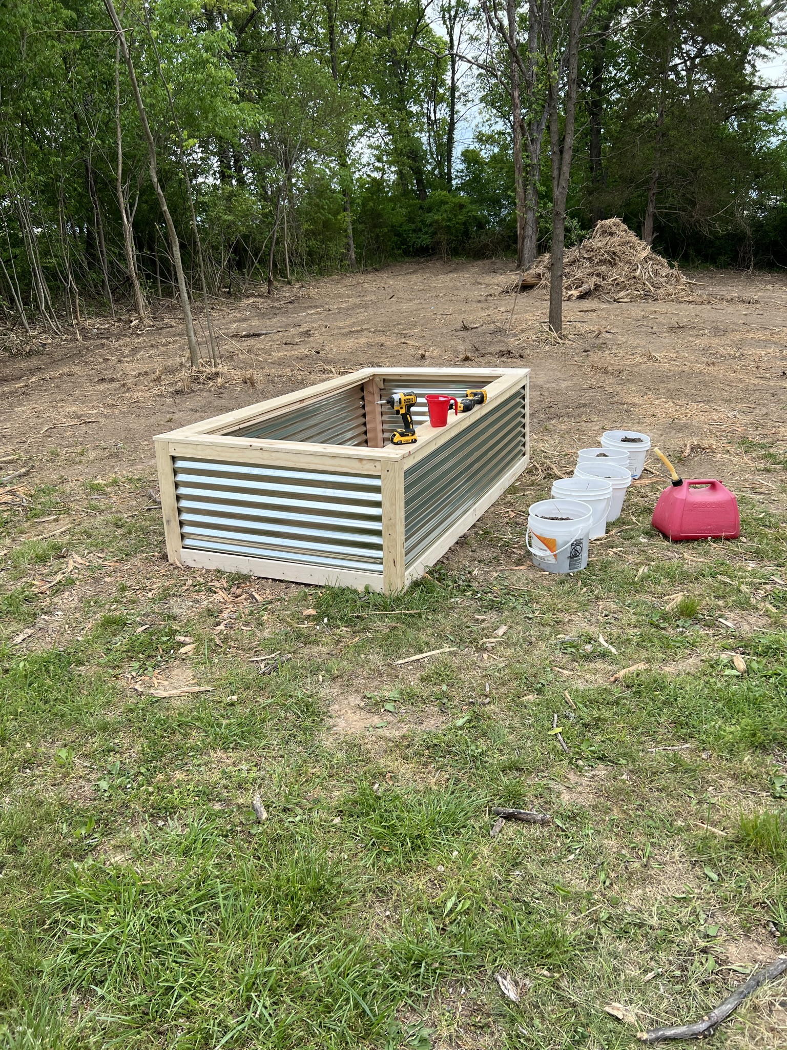 Wood-framed raised garden bed with corrugated metal sides